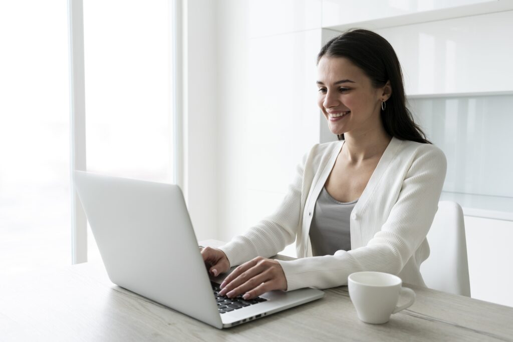medium shot woman working laptop min